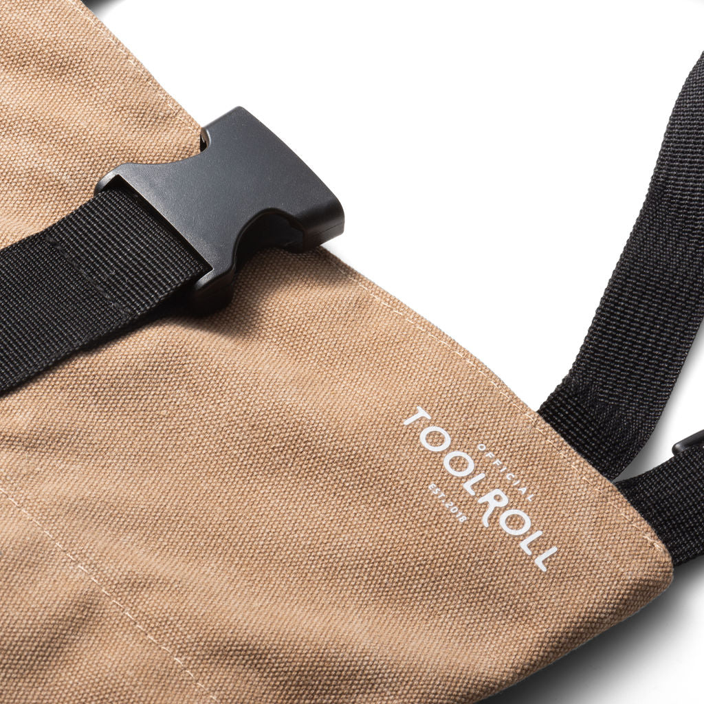 closeup picture of the buckle of a khaki legacy tool roll